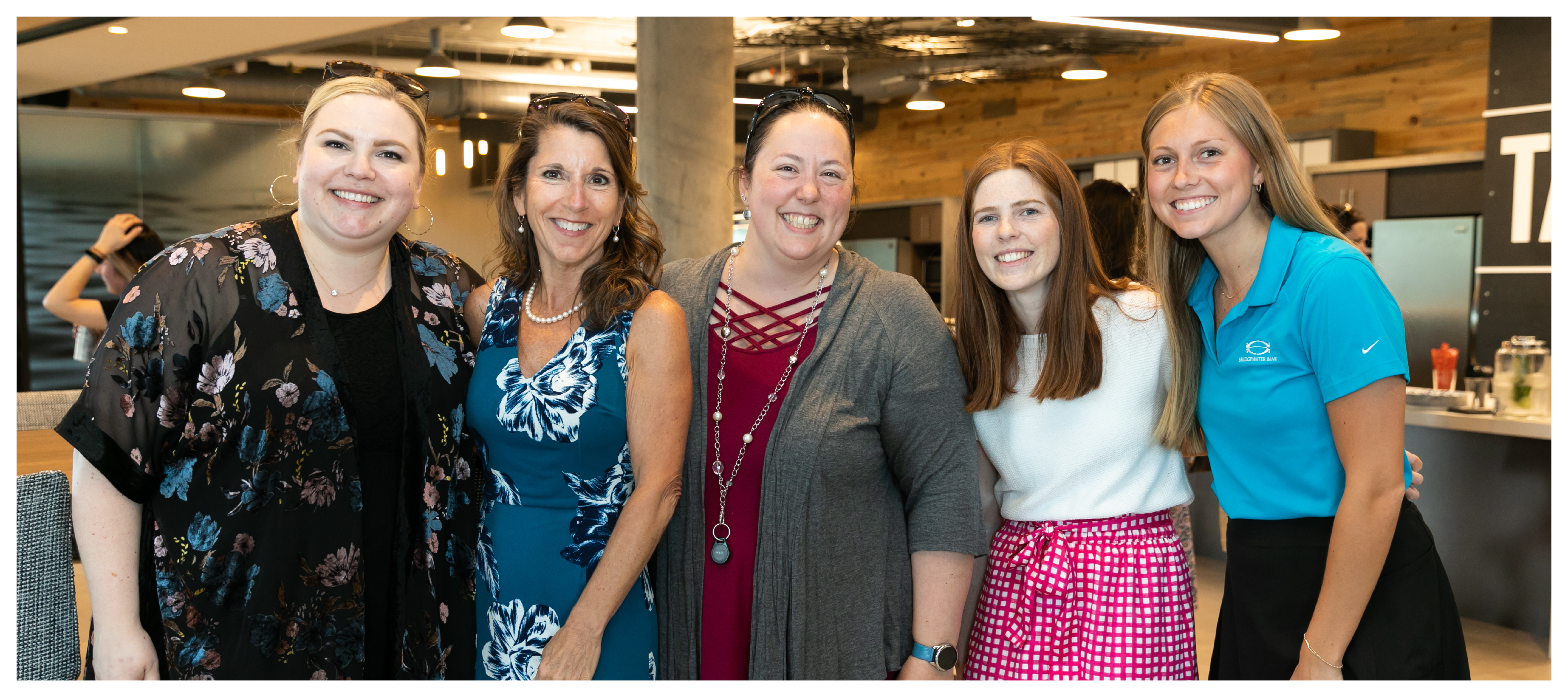 Group photo of Discovery Trust Group women at an internal happy hour.